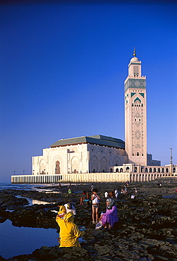 People at the reef and mosque Hassan II under blue sky, Casablanca, Morocco, Africa