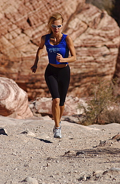 Woman jogging, running in Joshua Tree National Park, California, USA