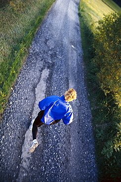 Jogger on country road, Stubaital Valley, Tyrol, Austria