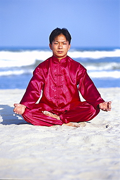 Young man doing Yoga on the beach, China Beach, Danang, Vietnam, Asia