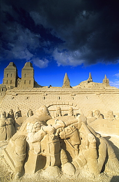 Artful sand sculptures under dark clouds, Travemuende, Schleswig Holstein, Germany, Europe