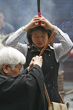 Longhua Temple, Longhua Temple and pagoda, oldest and largest buddhist temple in Shanghai, burning joss sticks, incense