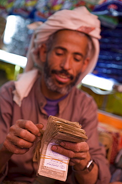 Man counting money, Sana'a, Yemen