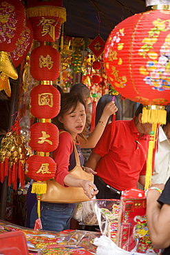 Woman choosing lampion in a shop at Yaowarat Road, Chinatown, Bangkok's oldest residentail and business district, Bangkok, Thailand