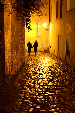 Couple walking down an alley, Mala Strana, Little Quarter, Prague, Czech Republic