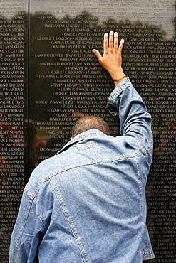 A man at the Vietnam Veterans Memorial, Washington DC, United States, USA