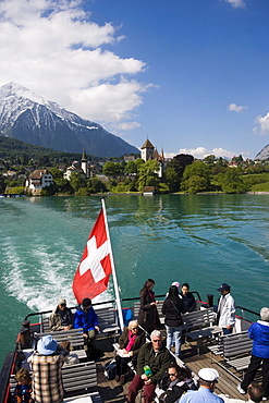 Excursion boat leaving Spiez, view to castle and castle church of Spiez, Lake Thun, Bernese Oberland (highlands), Canton of Bern, Switzerland