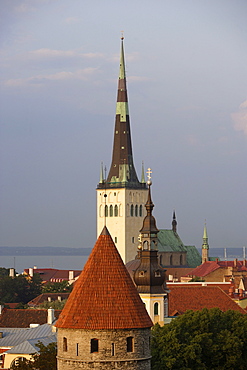 View over the old town of Tallinn seen from Rohukohtu terrace. One of the tower of the city walls in the front, St. Michael's monastery and St. Olaf's Church in the back, Tallinn, Estonia