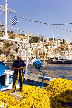 Fisherman sorting yellow flue, Simi, Symi Island, Greece