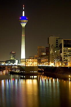 Modern architecture of the Media Harbour at night with television tower, Neuer Zollhof, Duesseldorf, state capital of NRW, North-Rhine-Westphalia, Germany