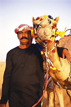 A local man, Bedouin, with camel, Desert, Dubai, United Arab Emirates