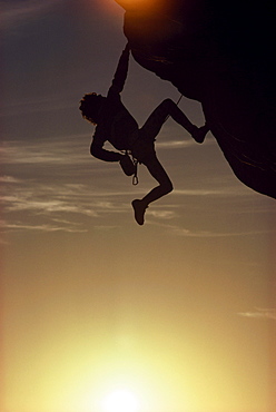 Silhouette of a man free climbing at Mount Arapiles at sunset, Rock Face, Sport, Victoria, Australia