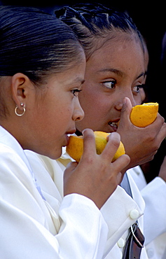 Two children eating oranges, San Miguel de Allende, Mexico