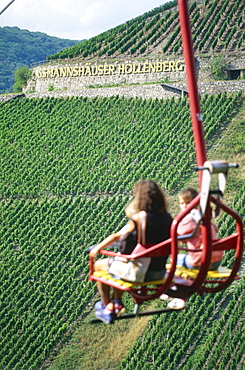 Persons in chair lift passing vineyard, Assmannshausen, Rhine District, Hesse, Germany