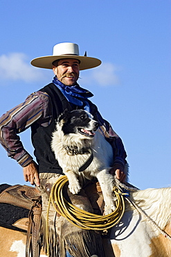 cowboy sitting on horseback with dog, wildwest, Oregon, USA