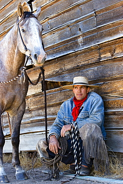 cowboy with horse at barn, wildwest, Oregon, USA