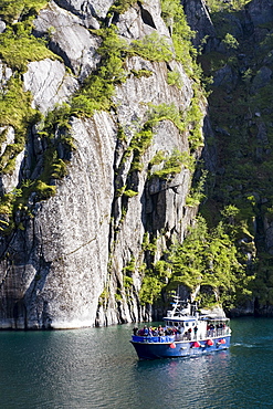 An excursion boat on a Fiord at the Island of Austvagoya, Trollfjord, Lofoten, Norway