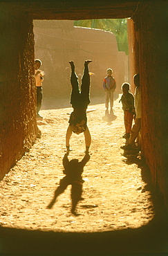 Boy doing handstand, Algeria, Africa