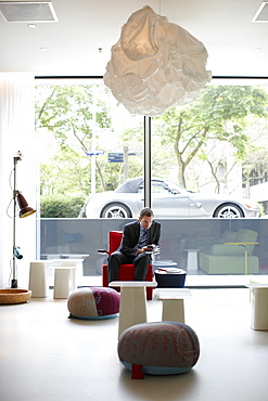 Guest in the Lobby with designer furniture, Citizen M Hotel, Amsterdam, Netherlands