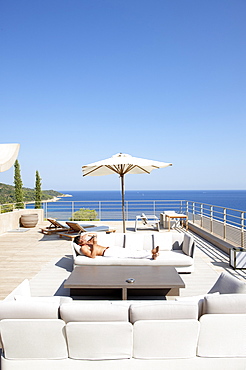 Man sunbathing on a hotel terrace, Ramatuelle, Provence-Alpes-Cote d'Azur, France