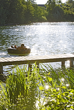 Boy bathing at Wesslinger Lake on a summer's day, Bavaria, Germany