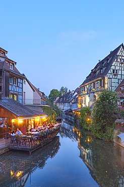 Restaurant and half timbered houses at the Lauch river in the evening, Little Venice, Colmar, Alsace, France, Europe