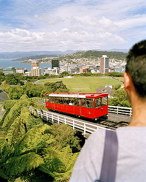 View over cable car at high rise buildings on the waterfront under clouded sky, Wellington, North Island, New Zealand