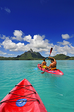 Couple with paddel boat, Bora Bora, Society Islands, French Polynesia, Windward Islands, South Pacific