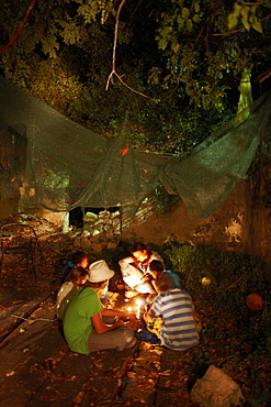 Children listening to stories about robbers in candlelight, kids programm by tour operator Vamos, Hotel Sipan, Sipanska Luka, Sipan island, Elaphiti Islands, northwest of Dubrovnik, Croatia