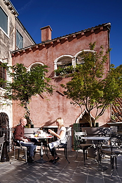 Guests having breakfast at a hotel rooftop terrace, Venice, Veneto, Italy