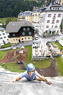 Boy on a climbing wall, centre of Bad Gastein, Salzburg, Austria