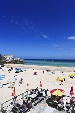 People sunbathing at Porthminster Beach, St. Ives, Cornwall, England, United Kingdom