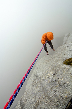 Climber roping in the fog, Tyrol, Austria, Europe