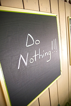 Blackboard with relaxing slogan of the day, Do Nothing, Little Palm Island Resort, Florida Keys, USA