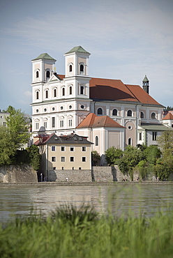 view of St. Michael's church with Inn river in the foreground, old town of Passau, Bavaria, Germany