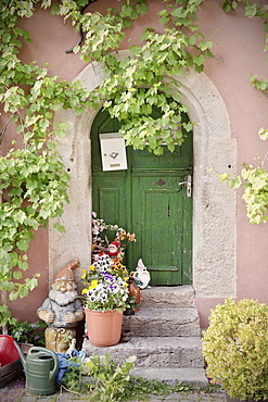 Decorated front door with flowers and garden gnome, Rothenburg ob der Tauber, Romantic Road, Franconia, Bavaria, Germany