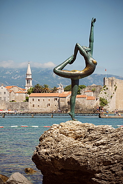 Sculpture of a nude female acrobat in front of old town of Budva, Stari Grad, Adriatic coastline, Montenegro, Western Balkan, Europe