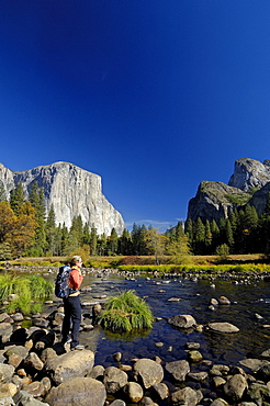 Female hiker enjoying view over Merced River, Yosemite National Park, California, USA