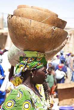 Woman carrying a calabash on her head at the Monday Market, Djenne, Mali