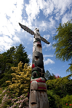 Contemporary Coast Salish totem pole carved by Doug LaFortune in Butchart Gardens, Victoria, British Columbia, Canada