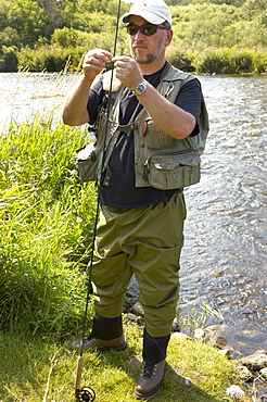 Man Preparing Rod for Fly Fishing, Grand River, Ontario