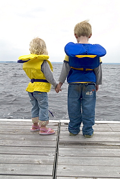 Brother and Sister Holding Hands on a Dock in Life Jackets, Lake Muskoka, Bracebridge, Ontario