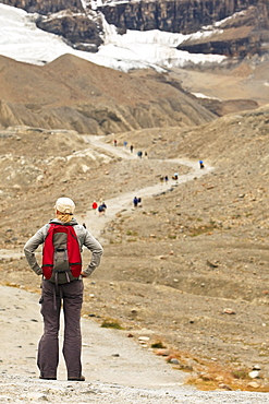 Woman hiker on trail to Athabasca Glacier, Columbia Icefields, Jasper National Park, Alberta