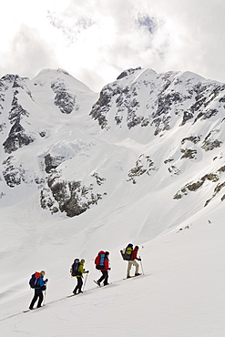 Snowshoers ascend to Vantage Pass with Anniversary Glacier and Joffre Peak in background, British Columbia