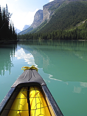 The front of a canoe heading into the Narrows in Maligne Lake, Jasper National Park, Alberta