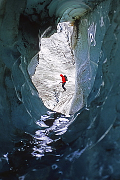 Hiker Exploring a Small Ice Cave on the Llewellyn Glacier, Atlin British Columbia