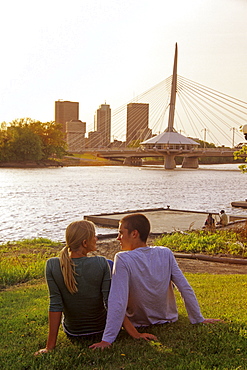 Teens Relaxing with Skyline and Red River in background, Winnipeg, Manitoba