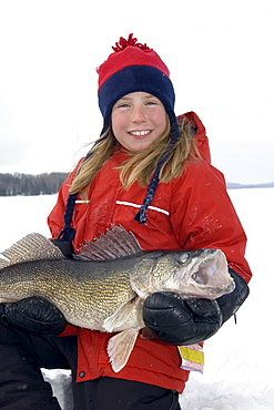 Young Girl Ice Fishing holding a Walleye, Wawa, Ontario