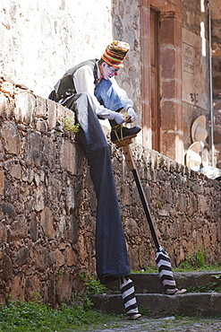 Clown putting on stilts, Putzcuaro, Michoacun, Mexico