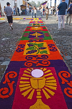 Carpet made of sand & sawdust along the Good Friday processional route. Carpet-making is thought of as a sacrificial act, as the elaborate detail and time that go into the carpet making is a way for people to give something of themselves in memory of the crucifixion of Jesus. These carpets last on average 2 hours before they are destroyed by the many feet that march over them during a procession in Antigua Guatemala., Sacatepuquez, Guatemala